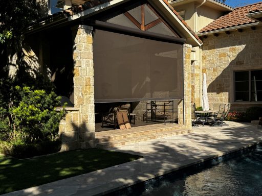 Custom motorized patio screen with flush-mounted tracks, designed to withstand high winds in Texas