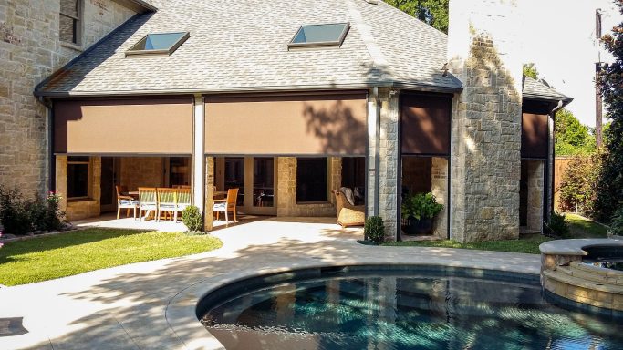 "Motorized patio screens providing shade and comfort, transforming an outdoor space into a usable retreat."

