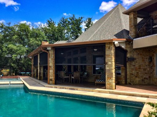 "Luxury poolside patio with motorized retractable screens for shade, privacy, and year-round comfort."

